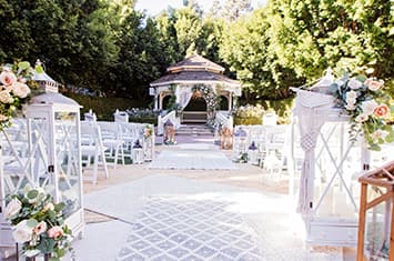 A flower lined aisle leading up to a gazebo at the Rose Court Garden in the Disneyland Hotel