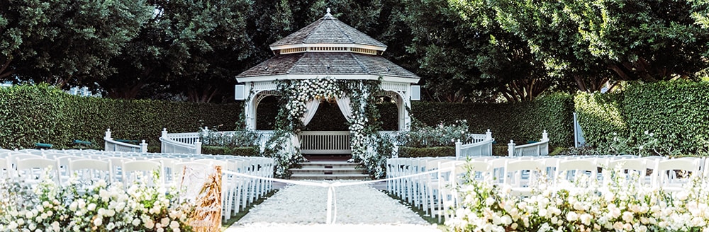 Rose petals scattered along a walkway leading towards a gazebo