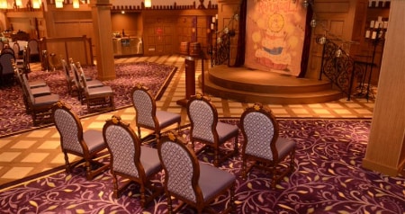Chairs and a podium set up for a wedding ceremony at Rapunzel’s Royal Table on the Disney Magic