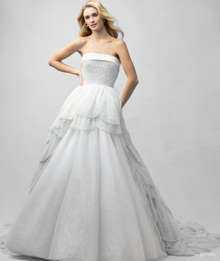 The front of a bride wearing an Ariel inspired ball gown featuring a straight neckline and a beaded bodice