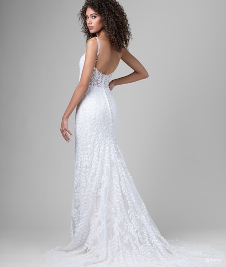 The back of a bride wearing a Pocahontas inspired sheath gown featuring a square neckline and leaf detail using lace and sequins