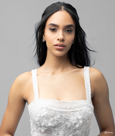 The bodice of a bride wearing a Snow White inspired ball gown featuring lace detail and a square neckline The bodice of a bride wearing a Snow White inspired ball gown featuring lace detail and a square neckline