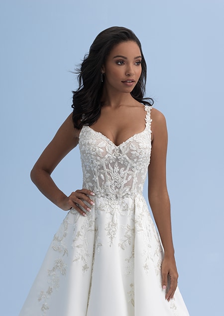 A woman in wedding dress adorned with crystal, embroidered flowers