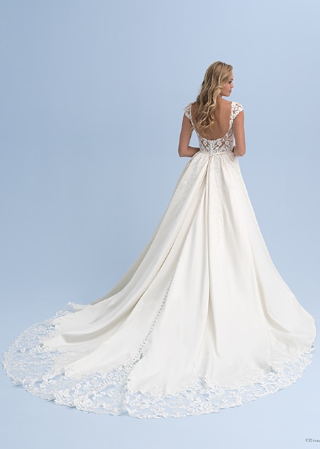 The back view of a bride wearing a wedding dress with cap sleeves and lace at the end of the train The back view of a bride wearing a wedding dress with cap sleeves and lace at the end of the train