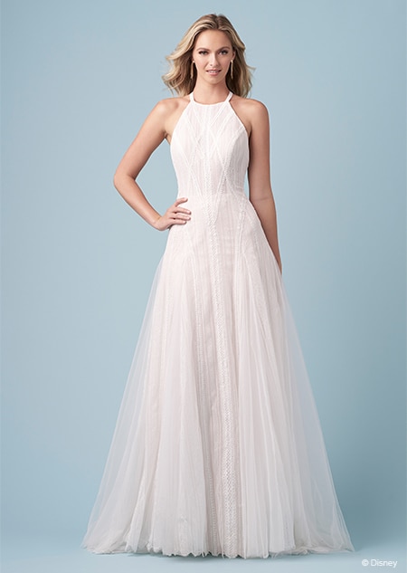 A bride wearing a Pocahontas inspired A line gown featuring an apron neckline