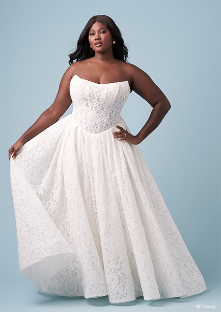A bride wearing a strapless Snow White inspired A line gown featuring a scoop neckline