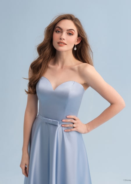 A woman wearing a Cinderella themed bridesmaid dress with a sweetheart neckline
