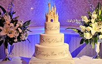 A wedding cake with a Cinderella Castle themed cake topper