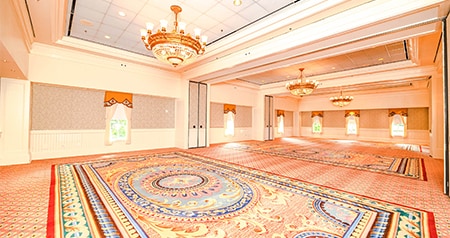 An intimate ballroom at Disney’s BoardWalk Inn featuring chandeliers