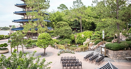 Chairs arranged in rows for an outdoor wedding beside a pagoda in the Japan Pavilion at Epcot