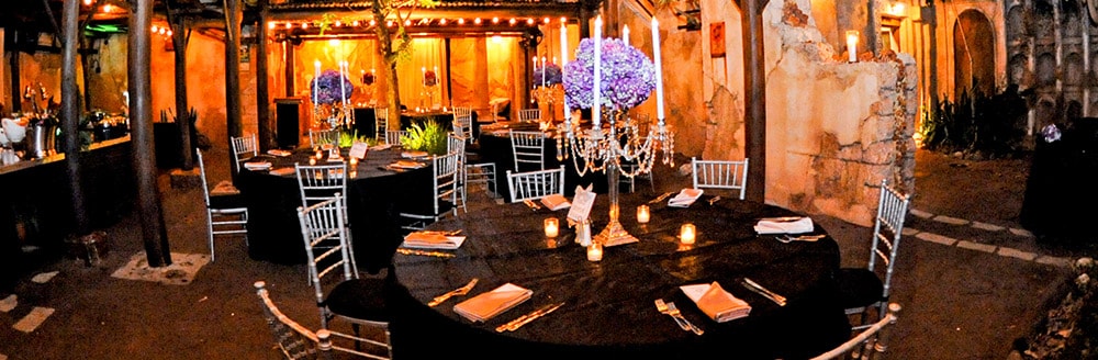 Round tables with tall candlesticks as centerpieces