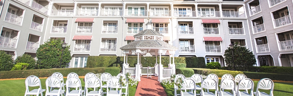 Two sections of a chairs face a gazebo in a hotel courtyard