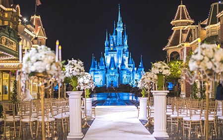 Florida Wishes Wedding Venues Disney S Fairy Tale Weddingsflorida Rows Of Chairs And Flowers Arranged For A Wedding Ceremony With Castle As The Backdrop