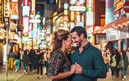 A couple embraces in the middle of downtown Tokyo, Japan