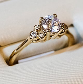 Close up of diamond wedding ring with gold band.
