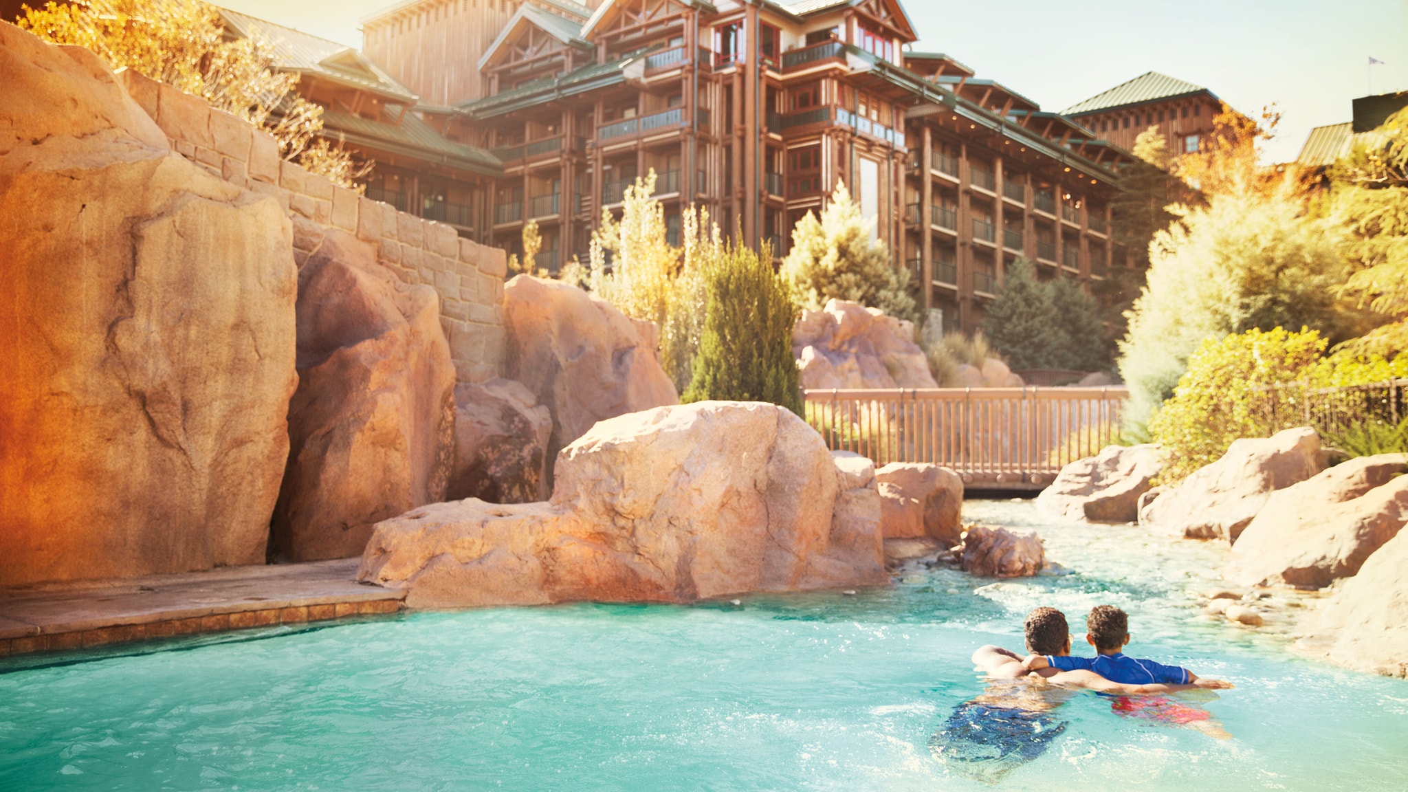 A father and son swim arm in arm in the Copper Creek Springs pool