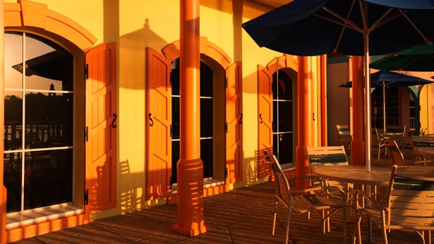 An outdoor seating area with tables, chairs and umbrellas