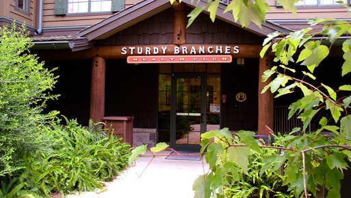 A log cabin-style building with a sign reading