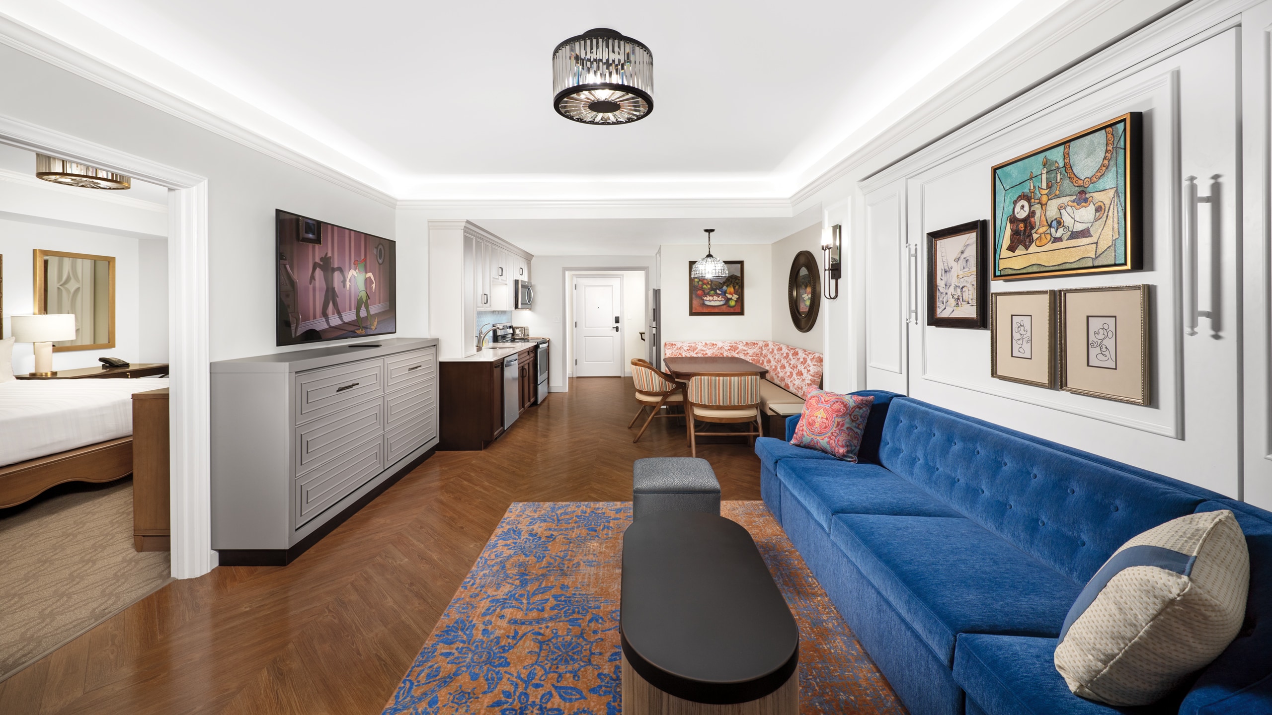 The kitchen, dining area, living area and private bedroom of a Villa at Disney’s Riviera Resort