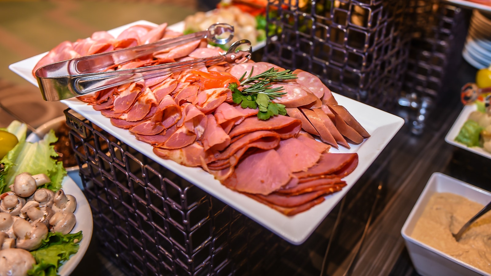 A plate of sliced charcuterie A plate of sliced charcuterie