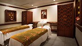 Two massage tables in an Asian-themed spa treatment room
