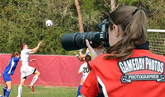Photography A GameDay Photos photographer snaps a picture of girls playing soccer