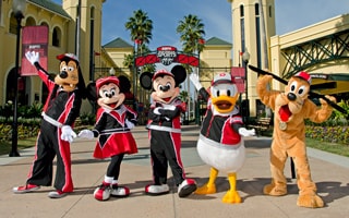 Goofy, Minnie Mouse, Mickey Mouse, Donald Duck and Pluto pose in matching athletic garb