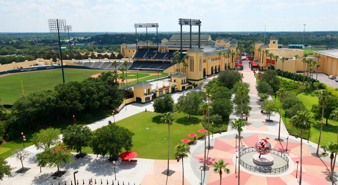 Home Slide - Complex A courtyard and walkway and, beyond, Champion Stadium and PlayStation Pavilion