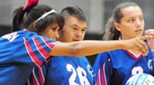 Special Olympics Thumbnail Young Special Olympics athlete receives instruction from volleyball teammate.